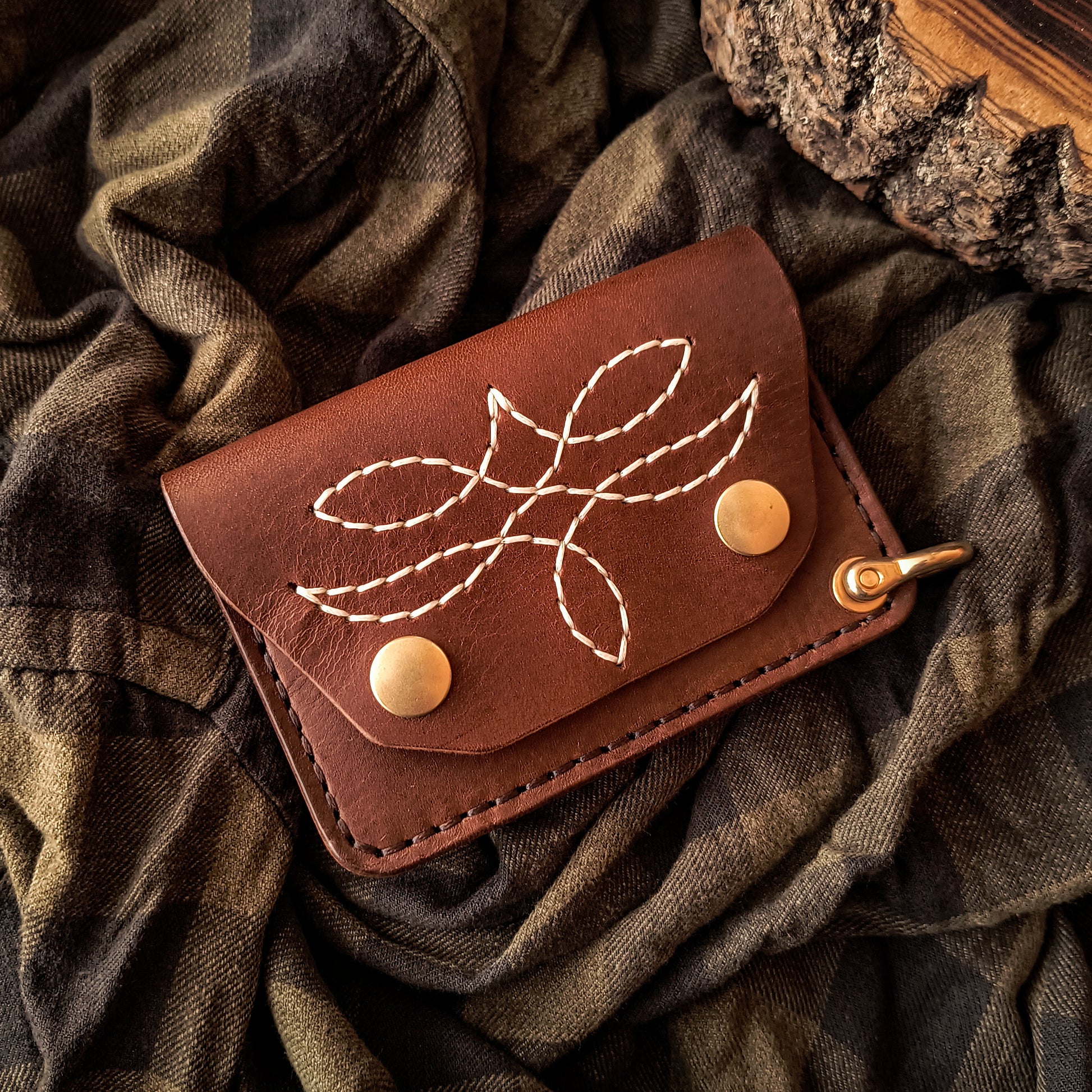 Handmade brown leather trucker wallet in compact design with hand-stitched pattern and solid brass hardware 