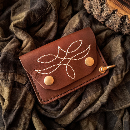 Handmade brown leather trucker wallet in compact design with hand-stitched pattern and solid brass hardware 