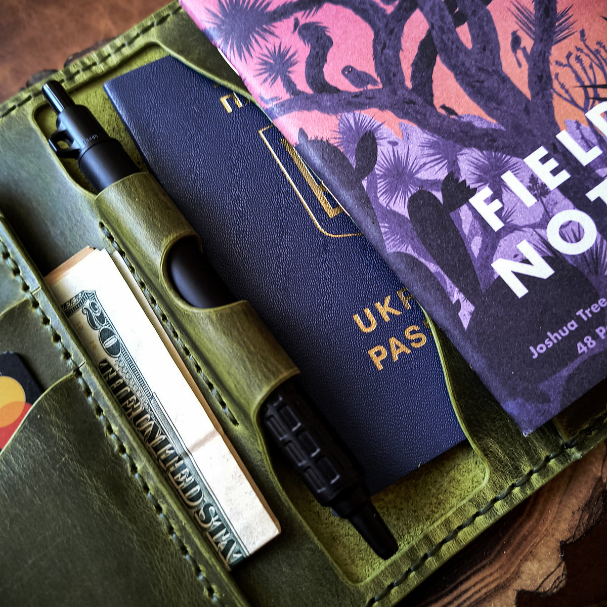 Pistachio green leather organiser with pen holder and slots for Field Notes, passport, cards and cash