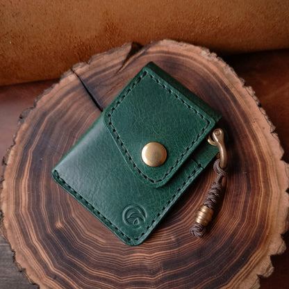 Compact everyday carry wallet made of emerald green vegetable tanned textured Italian leather amd fully solid brass hardware 