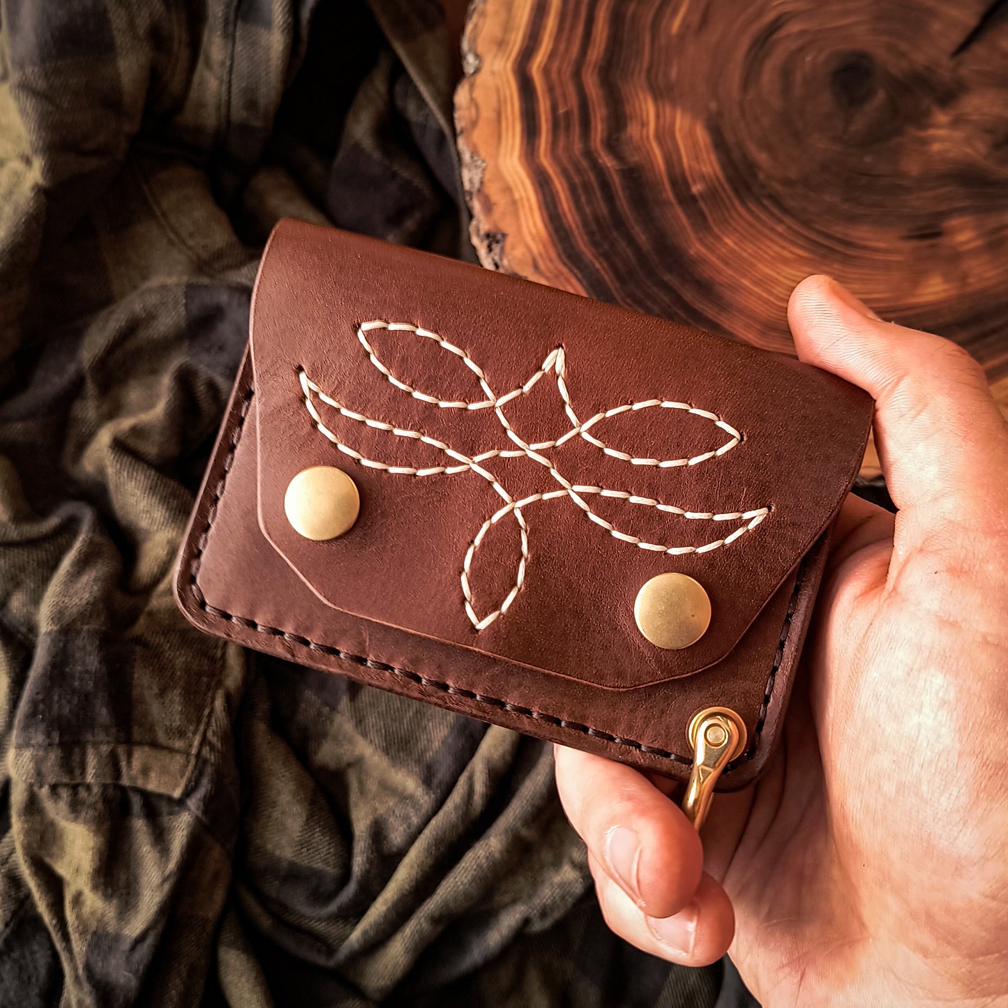 Compact handmade brown leather wallet in traditional style with hand-stitched pattern 